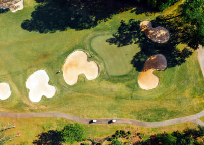 aerial view of golf course green and bunkers